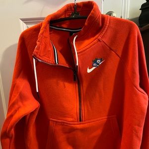 Nike quarter zip up. Orange with flowers surrounding logo.